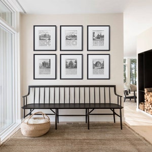 May include: A black wooden bench with a white fluffy cushion in a basket sits in front of a wall with six black framed prints of vintage illustrations. The prints are arranged in a grid pattern.