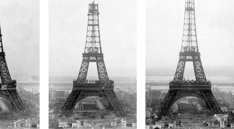 May include: Black and white vintage photograph of the Eiffel Tower under construction. The iconic wrought-iron lattice tower is partially built, with workers and construction materials visible at the base. The background shows a cityscape.