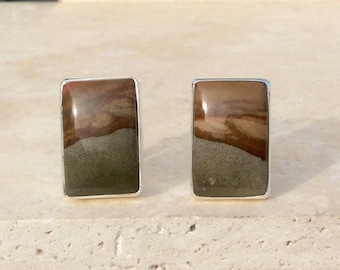 May include: A pair of silver earrings with rectangular brown and gray stone inlays.