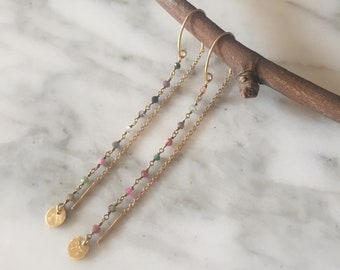 Rosario Topazes and medal earrings.