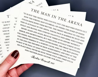May include: A set of four inspirational quote cards with a white background and black text. The quote is by Theodore Roosevelt and reads "It is not the critic who counts; not the man who points out how the strong man stumbles, or where the doer of deeds could have done them better. The credit belongs to the man who is actually in the arena, whose face is marred by dust and sweat and blood, who strives valiantly, who errs, who comes short again and again, because there is no effort without error and shortcoming, but who does actually strive to do the deeds, who knows great enthusiasms, the great devotions; who spends himself in a worthy cause; who at the best knows in the end the triumph of high achievement, and who at the worst, if he fails, at least fails while daring greatly, so that his place shall never be with those cold and timid souls who neither know victory nor defeat."