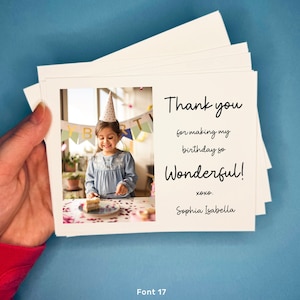 May include: A thank you card with a photo of a young girl wearing a birthday hat and holding a piece of cake. The text on the card reads "Thank you for making my birthday so Wonderful! xoxo. Sophia Isabella".