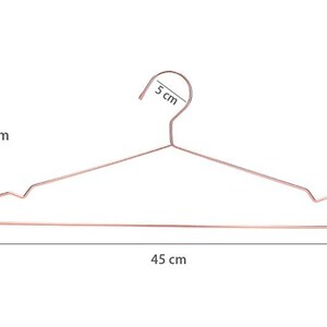 May include: Rose gold metal hanger with measurements: 18 inches tall, 5 inches wide at the top, and 45 inches wide at the bottom.