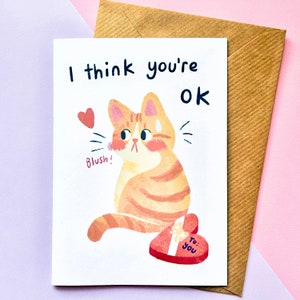 Tarjeta de San Valentín con un lindo gato pelirrojo tímido y reservado, tarjeta de felicitación ilustrada para el aniversario de San Valentín, tamaño A6