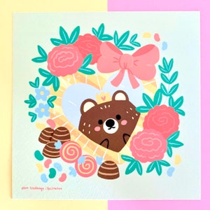 May include: A brown bear wearing a crown sits inside a heart-shaped frame surrounded by pink and blue flowers, candy, and a pink bow. The background is a light green.