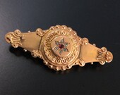 9ct gold Victorian bar brooch with ruby cluster and locket back