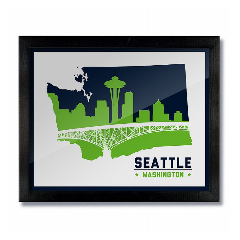 May include: A framed print of a green and blue silhouette of the Seattle skyline, including the Space Needle and a bridge, with the text "Seattle * Washington *" below.