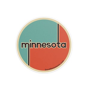 May include: Round sticker with a retro design featuring the word "minnesota" in a bold, sans-serif font. The sticker has a teal and orange color scheme, with a cream-colored border and a vertical black line. The website address "DandWelements.com" is at the bottom.