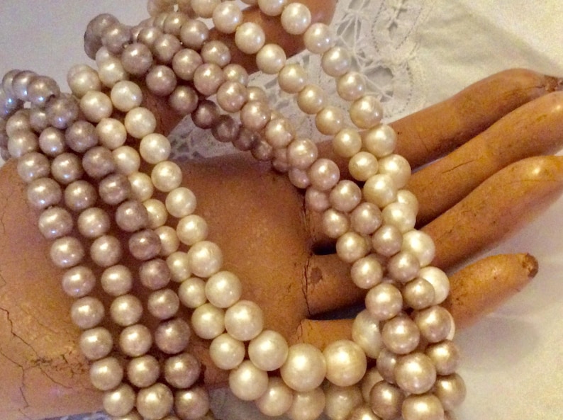 Four strands of neutral creams and champagne colored beaded bib necklace Lovely midcentury classic perfect with any outfit.
