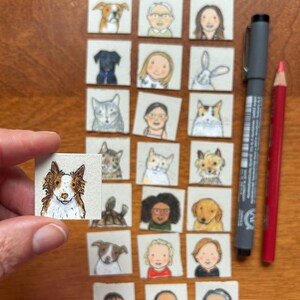 May include: A collection of small, square watercolor paintings featuring portraits of people and pets. A hand holds one painting of a dog. A gray pen and a red pencil are also in the image.