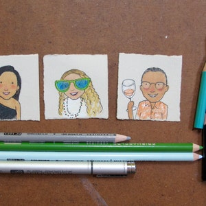May include: Three hand-drawn illustrations on paper, each depicting a person. The first person is a woman with long black hair wearing a black dress. The second person is a woman with long blonde hair wearing sunglasses and a necklace. The third person is a man with short brown hair wearing a light orange shirt and glasses. The illustrations are surrounded by colored pencils and a silver pen.
