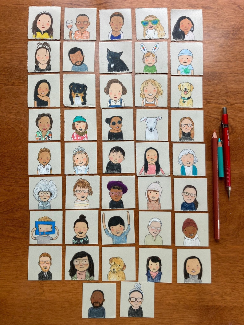 47 tiny 2 x 2 inch drawings are are arranged din a grid on a wooden table. They are colorful and cheery. There are people of all ages and ethnicities. there are dogs and cats too.