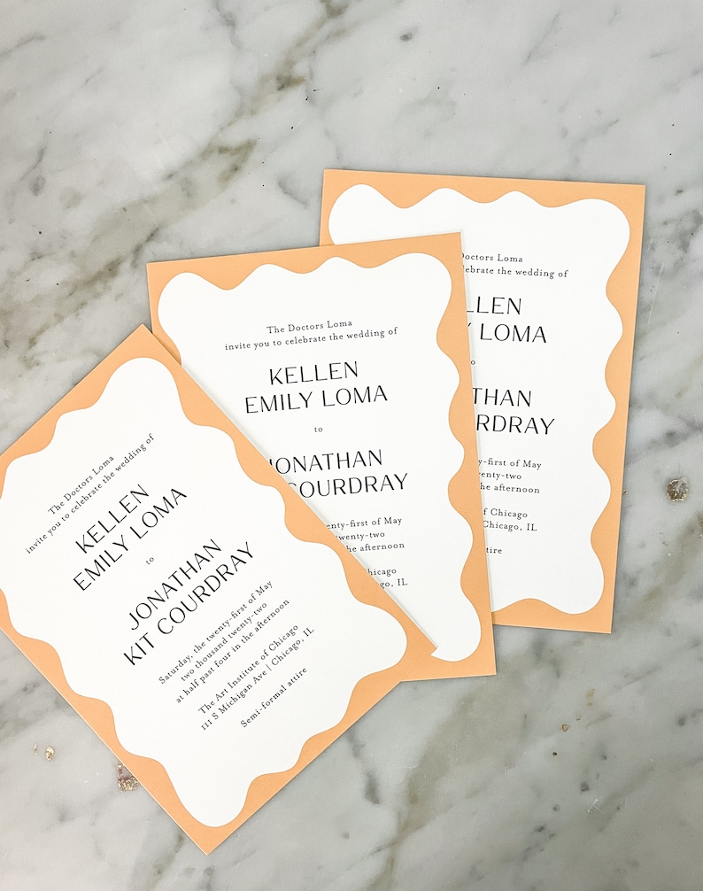 May include: Peach-colored wedding invitation with a wavy border. The invitation reads "The Doctors Loma invite you to celebrate the wedding of Kellen Emily Loma to Jonathan Kit Courdray" and includes the date, time, and location of the wedding.