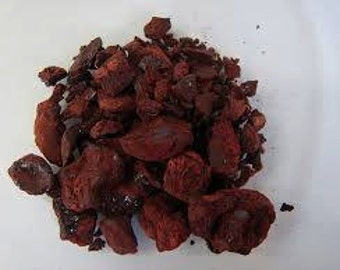 May include: A pile of dark red, irregularly shaped, rough-textured, dried pieces of resin.