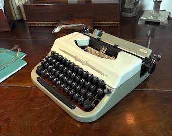 Swissa Junior Typewriter with Techno/Cubic typeface! Very portable with Swiss precision!   From 1965 with QWERTY keyboard and ready to type!