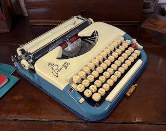 Princess 300 Typewriter with deLuxe Blue Case! Has the preferred QWERTY keyboard, uniform key-colour, and no paint-loss on ribbon cover!