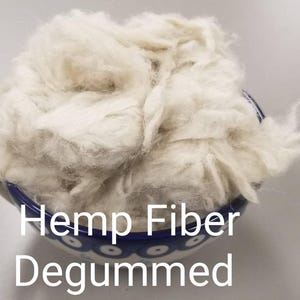 May include: A close-up of a bowl filled with white hemp fiber. The bowl is blue and white with a floral pattern. The text "Hemp Fiber Degummed" is printed below the bowl.