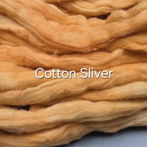 May include: Close-up of a pile of cotton sliver in shades of orange and yellow. The text "Cotton Sliver" is displayed in white across the image. The fibres are soft and wavy, suggesting a textile or craft material.