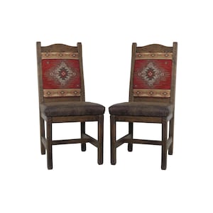 May include: Two wooden dining chairs with brown leather seats and red and brown patterned fabric backrests.