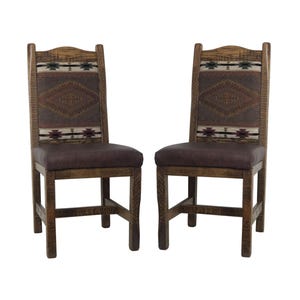 May include: Two wooden dining chairs with brown upholstery and a Southwestern-style patterned fabric backrest. The chairs have a rustic, distressed finish.
