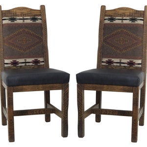 May include: Two wooden dining chairs with black leather seats and patterned fabric backrests. The fabric features a geometric design in shades of brown, red, and white.