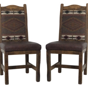 May include: Two wooden dining chairs with brown leather seats and woven patterned backs. The chairs have a rustic, southwestern style.