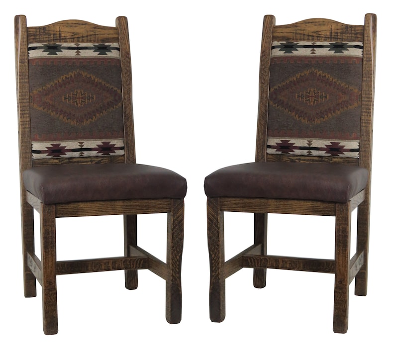 May include: Two wooden dining chairs with brown leather seats and woven patterned backs. The chairs have a rustic, southwestern style.