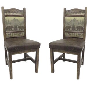 May include: Two wooden chairs with dark brown upholstered seats and high backrests. The backrests feature a woven fabric panel depicting a mountain landscape with bears and trees in shades of brown, green, and tan, set against a dark wood frame.