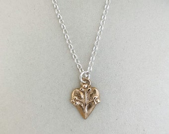 Medieval-inspired Heart Pendant with Three Flower Accents