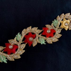 May include: Gold, red, and green embroidered trim with floral designs and rhinestones.