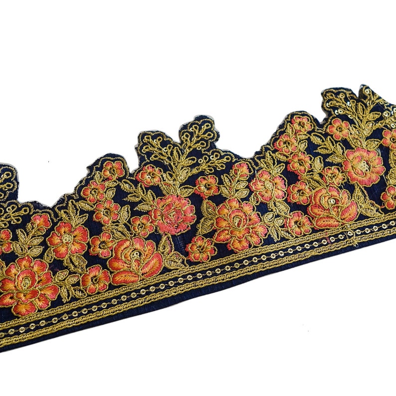 May include: Black lace trim with gold and orange floral embroidery. The trim has a scalloped edge and a beaded border.