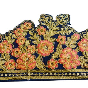 May include: A navy blue fabric trim with gold and orange embroidered floral designs. The trim has a scalloped edge and a row of gold sequins along the bottom.