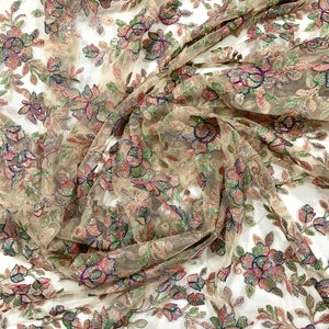 May include: Beige sheer fabric with embroidered floral pattern in shades of green, pink, and blue. The fabric is embellished with sequins and beads.