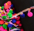 Multicolored pom poms tassels trim product logo