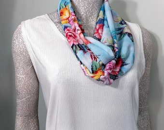 Light blue background with colorful floral bouquet on a lightweight polyester womans infinity scarf.   Classy, professional washable.*