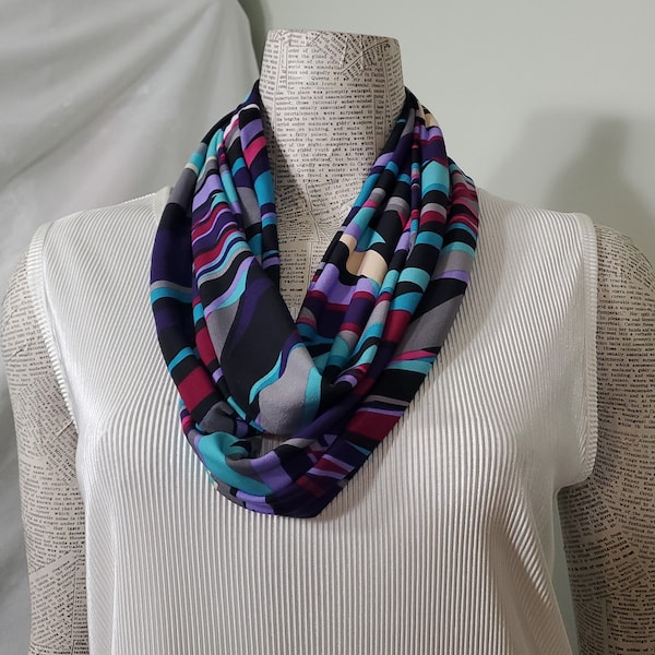 Bold jewel tones of purple raspberry teal lavender black tan & white on a lightweight ladies poly knit infinity scarf Beautiful drape casual