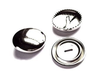May include: Three silver metal button parts for a shirt or jacket. The parts include a front, back, and a post.