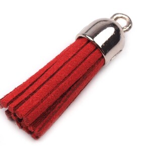 May include: A red suede tassel with a silver metal loop. The tassel is about 2 inches long.