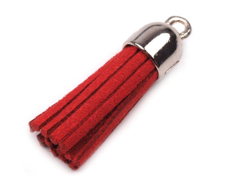 May include: A red suede tassel with a silver metal loop. The tassel is about 2 inches long.