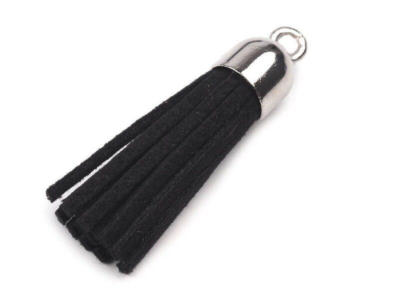 May include: Black tassel with a silver metal top and a loop for attaching to a bag or keychain.