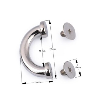 May include: Silver-toned metal U-shaped hook with two screws. The hook measures 2.7 inches long, 1.5 inches wide, and 0.5 inches high. The screws measure 0.3 inches in diameter.