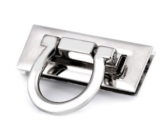 May include: A shiny, silver-colored rectangular clasp with a curved, D-shaped handle. The clasp has a polished finish, reflecting light. This hardware is suitable for bags, purses, or other craft projects.