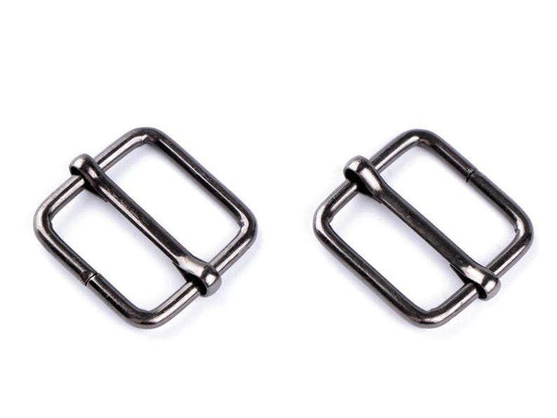 May include: Two silver-toned metal buckle closures. The buckles are rectangular with a smooth finish.