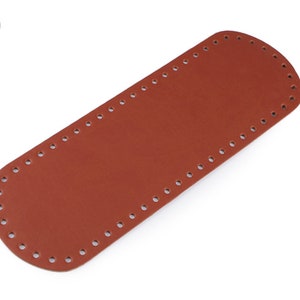 May include: A brown leather strap with evenly spaced holes for stitching. The strap is approximately 16 inches long.