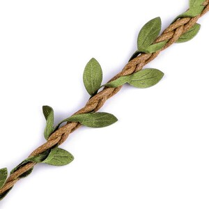 May include: A brown rope with green fabric leaves attached, creating a vine-like design.