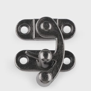 May include: A dark gray metal clasp with a curved latch and two mounting plates, each with two holes for screws. The clasp is designed to secure a box or container.