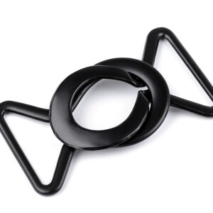 May include: Black metal buckle with a circular opening and a triangular loop. The buckle is designed for attaching straps or belts.