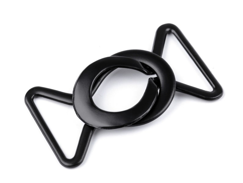 May include: Black metal buckle with a circular opening and a triangular loop. The buckle is designed for attaching straps or belts.