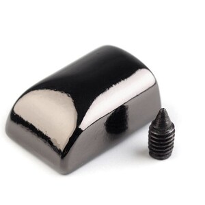 May include: A black metal furniture leg cap with a rounded top and a screw. The cap has a shiny, polished finish.