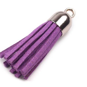 May include: A purple suede tassel with a silver metal top. The tassel is about 2 inches long.